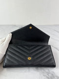 SAINT LAURENT BLACK CASSANDRE MATELASSÉ LARGE FLAP WALLET IN GRAIN DE POUDRE LEATHER