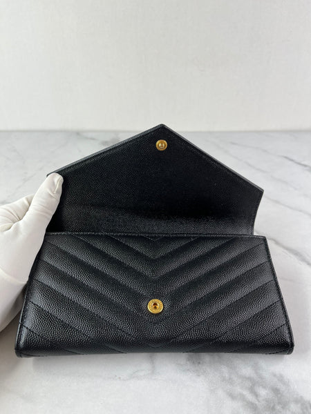 SAINT LAURENT BLACK CASSANDRE MATELASSÉ LARGE FLAP WALLET IN GRAIN DE POUDRE LEATHER